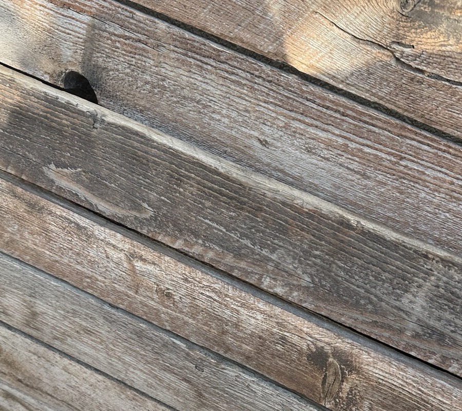 Close detail of weathered reclaimed barnwood grain and nail hole