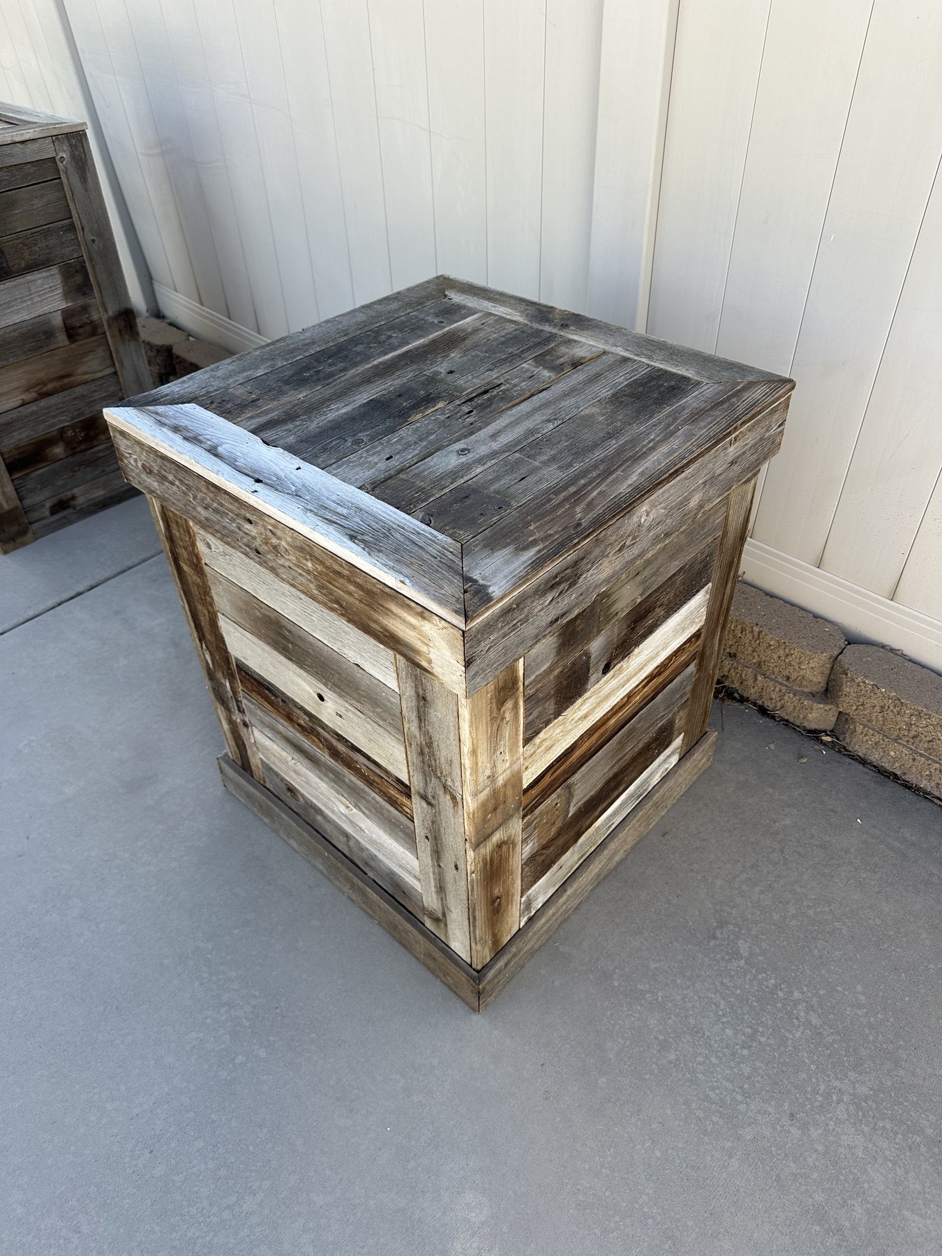 A crate-style barnwood pedestal built from mixed-tone reclaimed boards